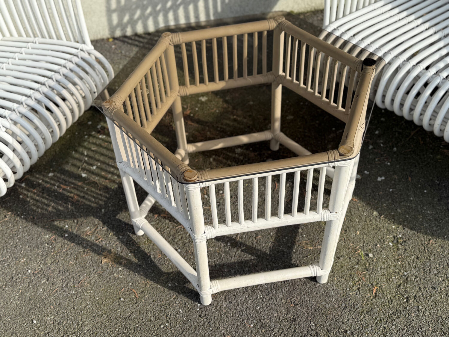Rattan lounge with two two-seater sofas and a white coffee table.