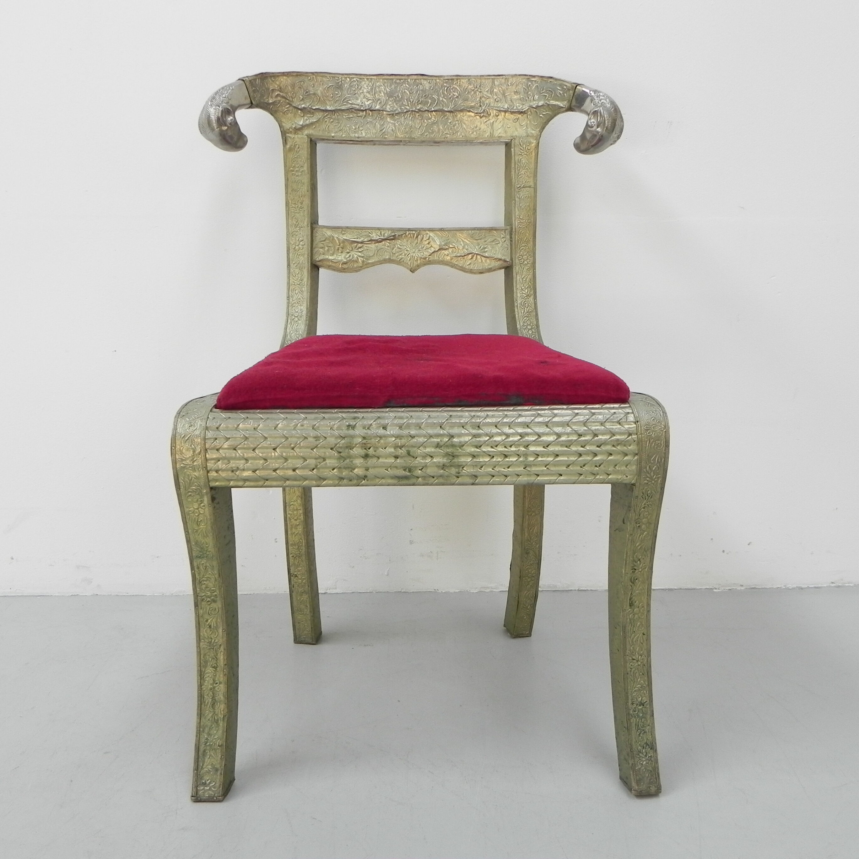 Dining chair upholstered with stamped tin