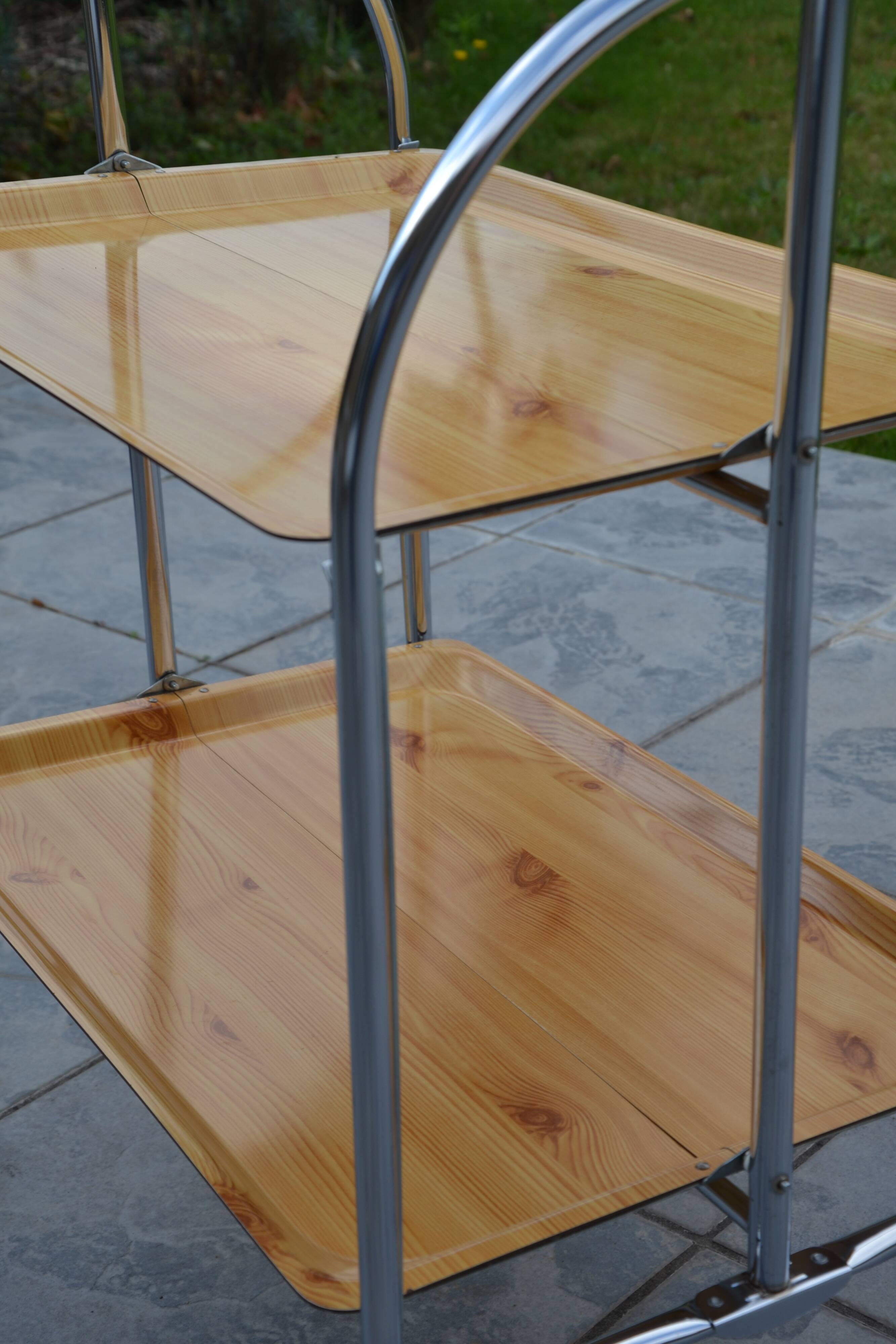 Folding dessert trolley on chrome metal wheels and formica.