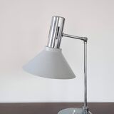 Chrome metal desk lamp and gray articulated arm