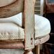 Medallion back chair in moulded wood and beige fabric.