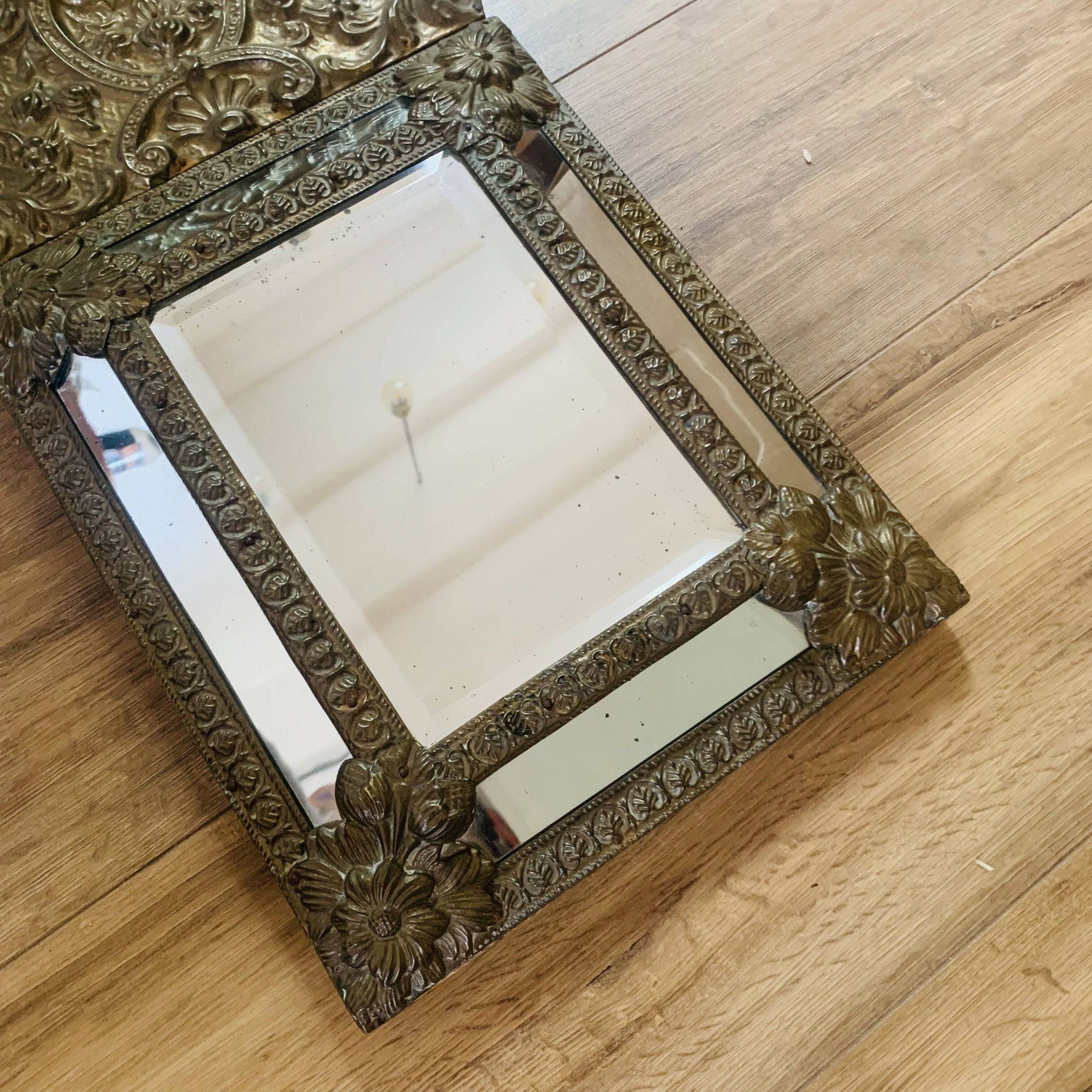 Small mirror with repoussé brass frame.