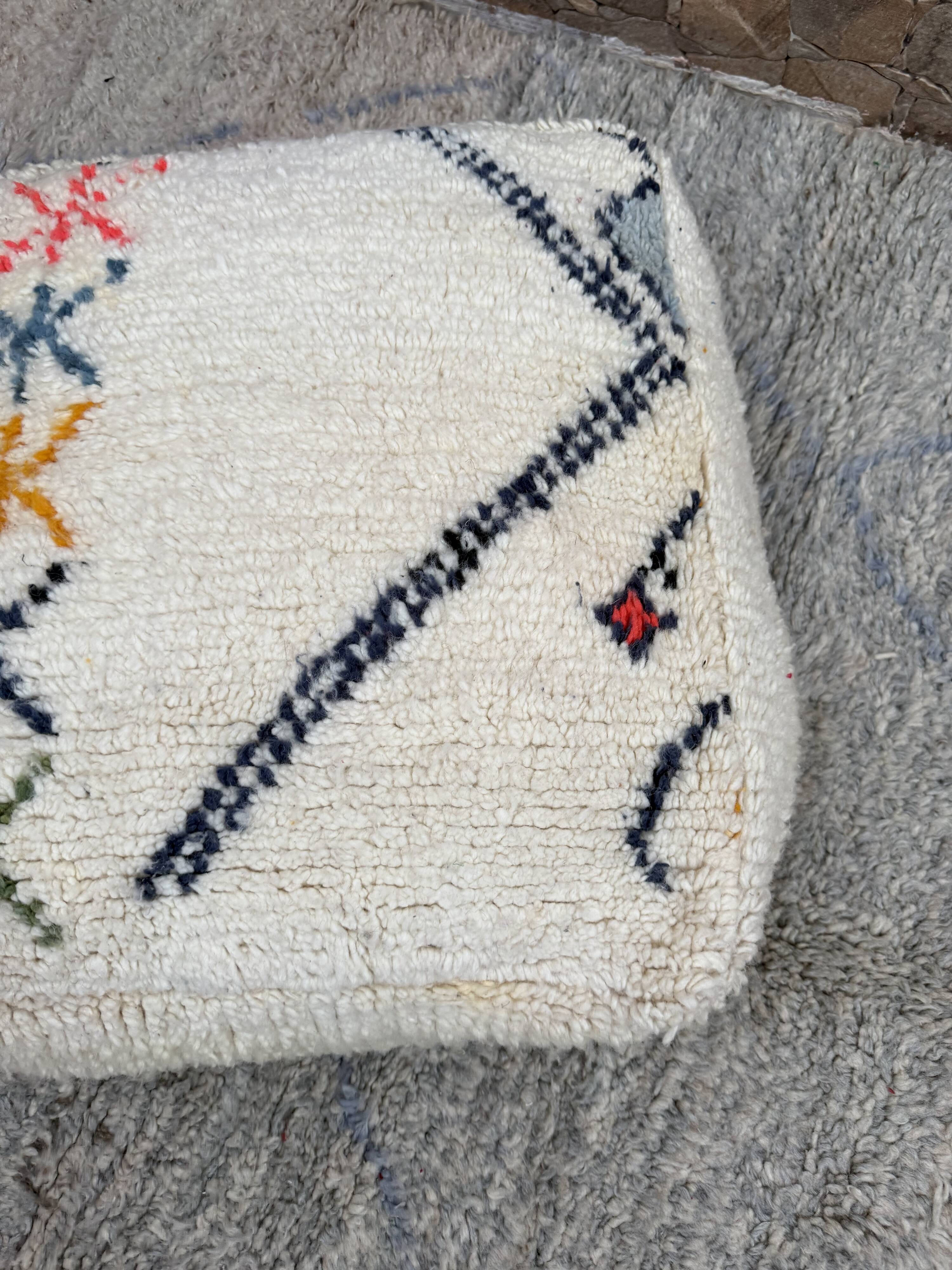 Berber floor pouf: Handwoven Moroccan wool cushion.