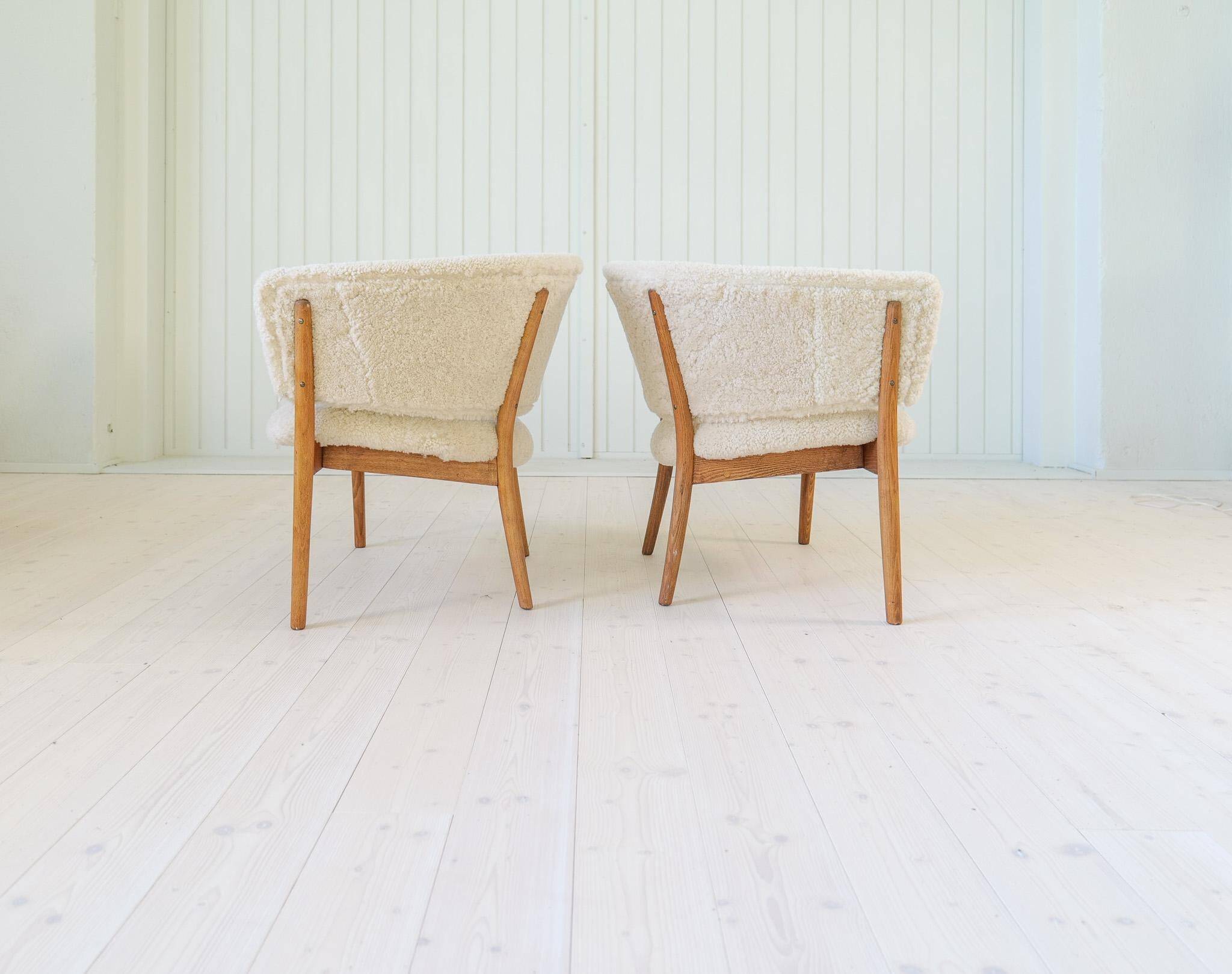 Mid-century lounge chairs in sheepskin/shearling and stained wood, Sweden, 1962.