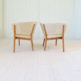 Mid-century lounge chairs in sheepskin/shearling and stained wood, Sweden, 1962.