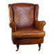Fauteuil à oreilles en peau de mouton subtile en bon état sur roulettes avant en laiton