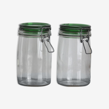 Pair of transparent glass jars and green lid