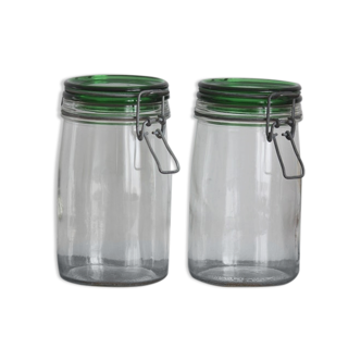 Pair of transparent glass jars and green lid