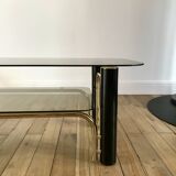coffee table in smoked glass and black and gold metal from the 70s