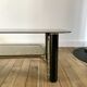 coffee table in smoked glass and black and gold metal from the 70s
