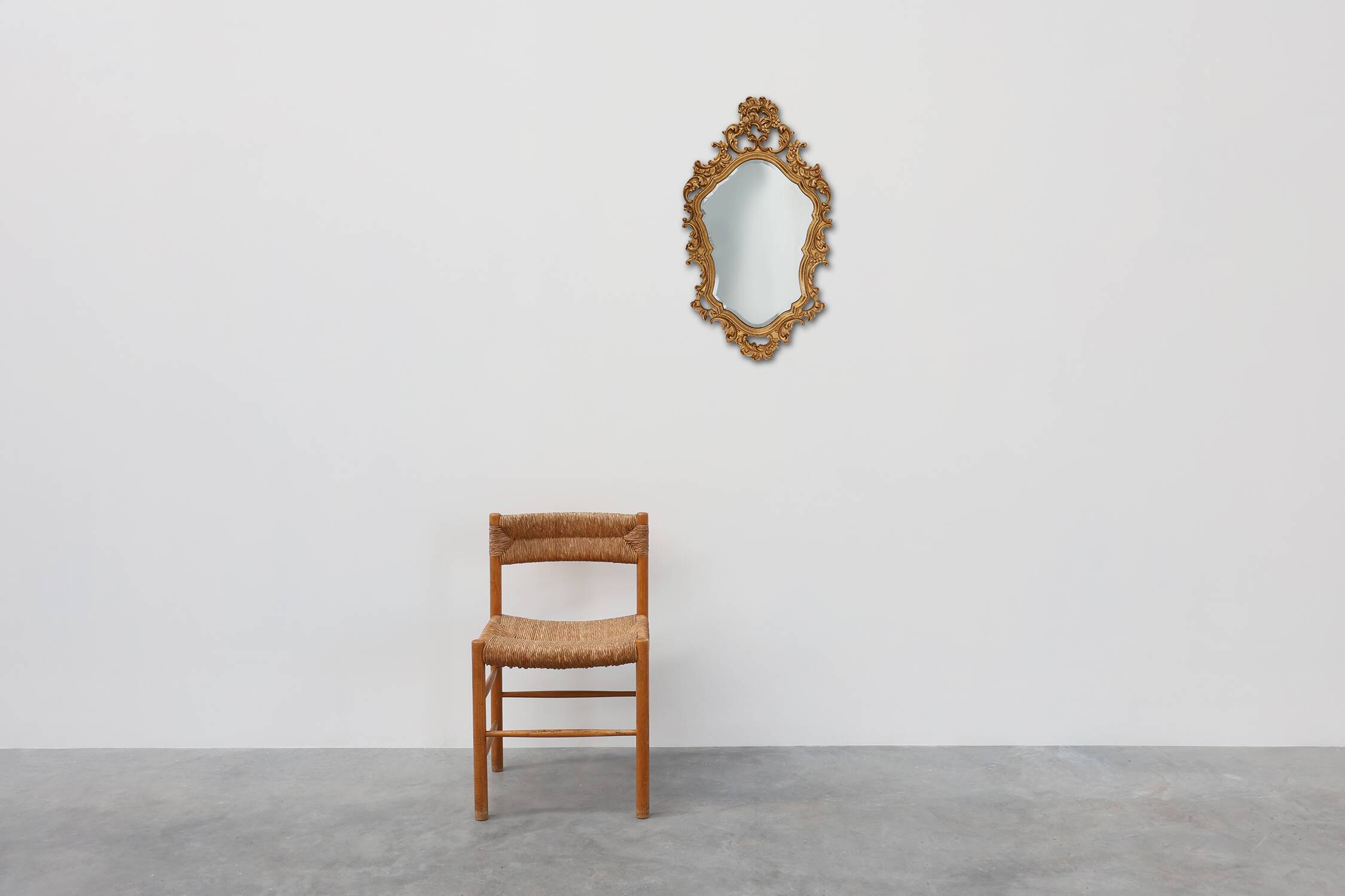 French Rococo or Baroque style facet-cut crest mirror in gilded carved wood