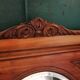 Old oval walnut wood mirror has flower carvings decoration
