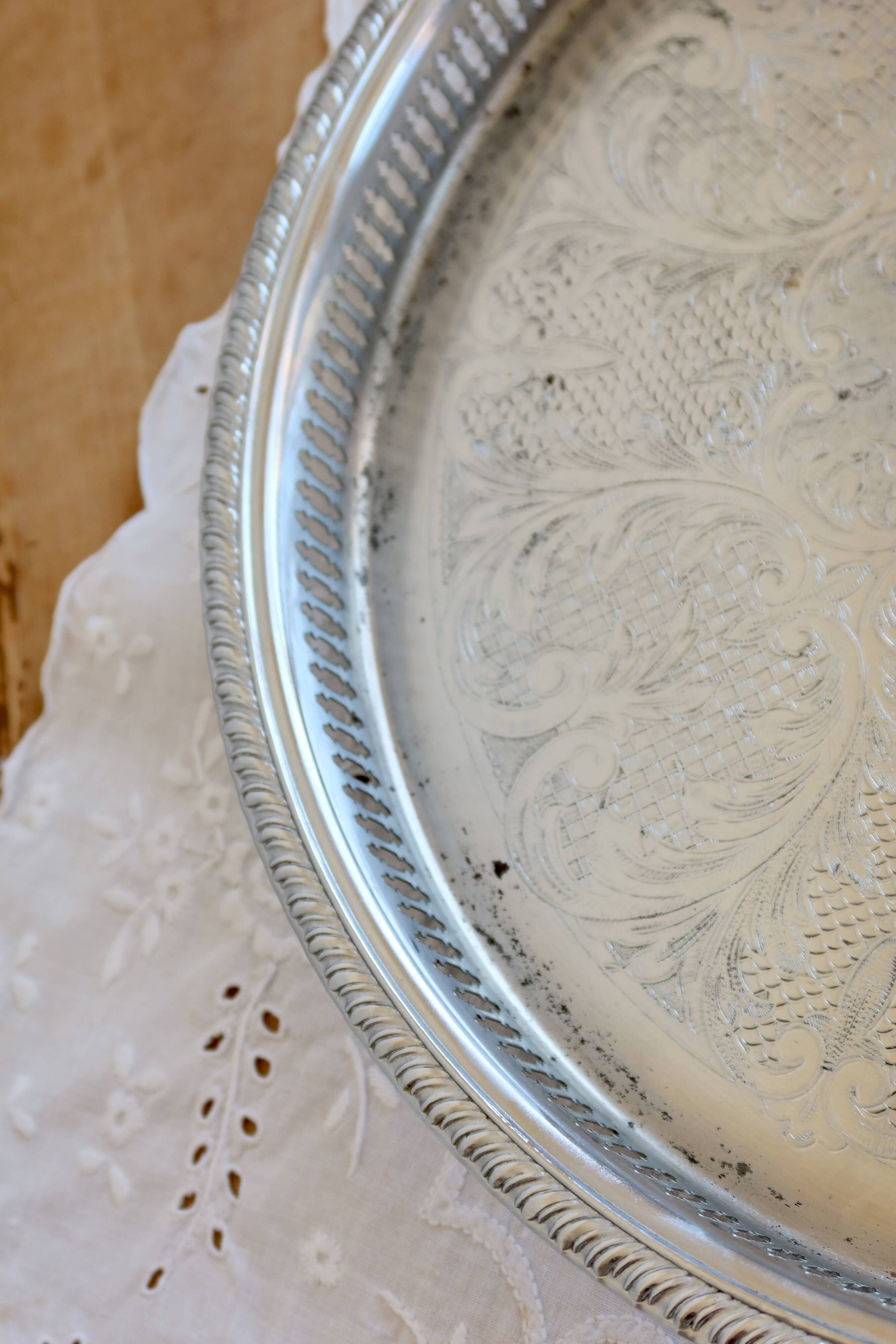 Large round vintage silver-plated metal tray, engraved and pierced.