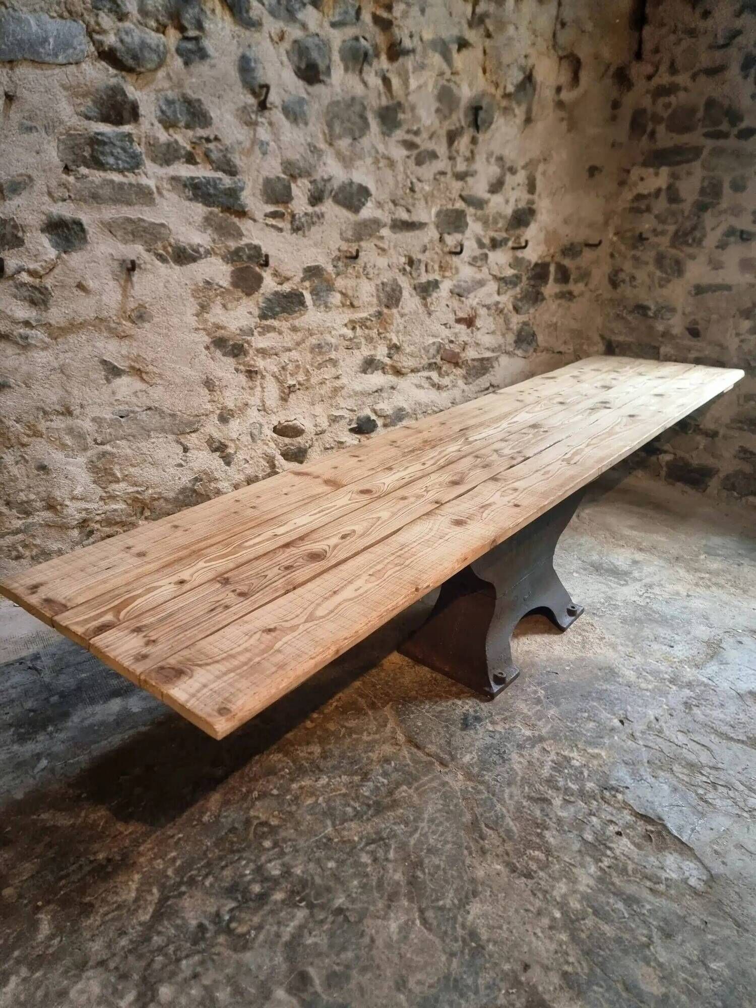 Old French industrial table with a cast iron base and a pine top.