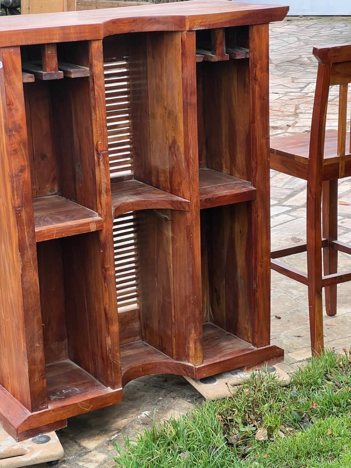 Exotic wood bar with 2 high stools.