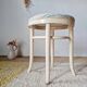 Vintage curved wooden stool in Baumann style, striped fabric seat.