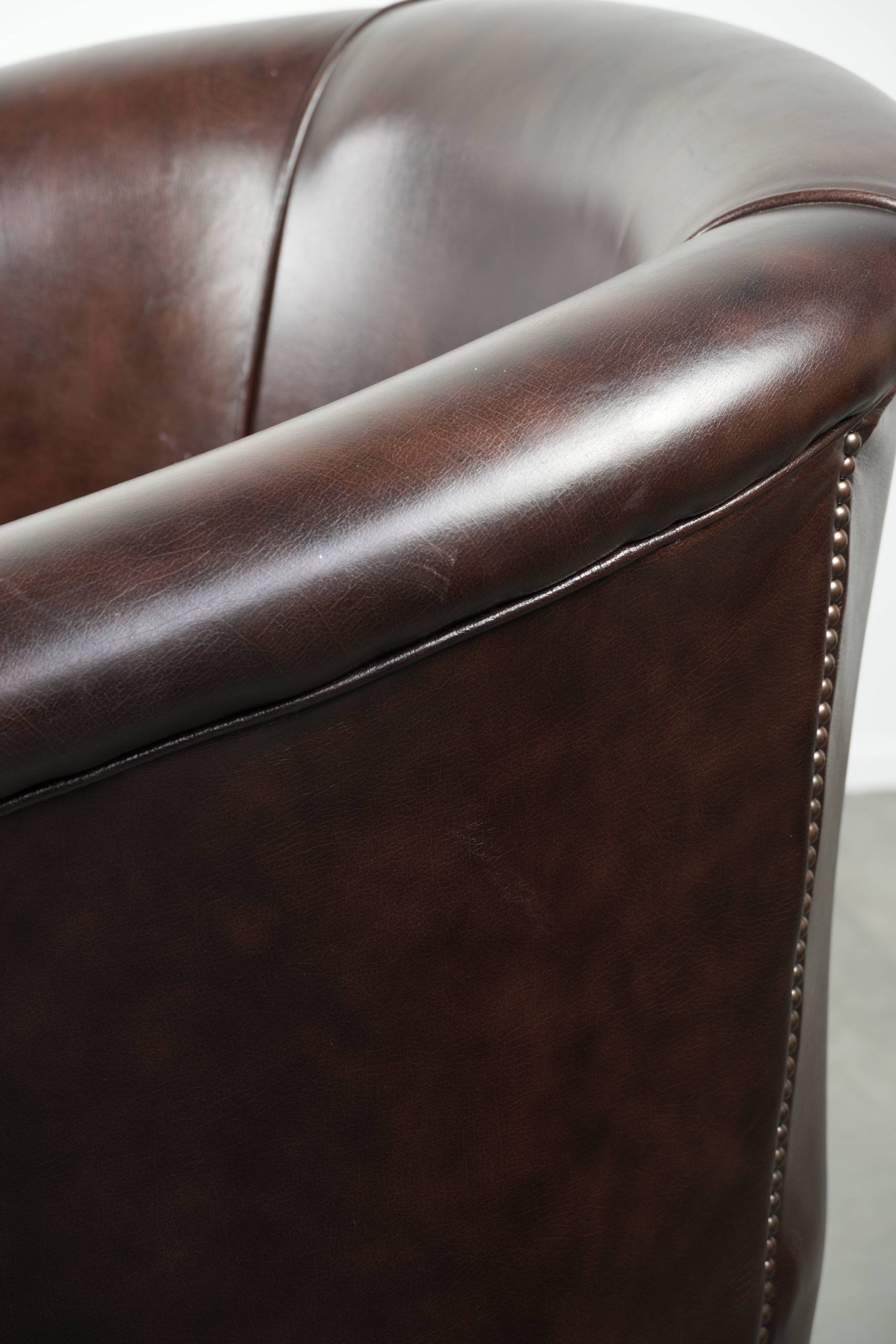 Dark cow leather club armchair in good condition with an English design