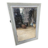 Old mirror with light green contours with mauve shades