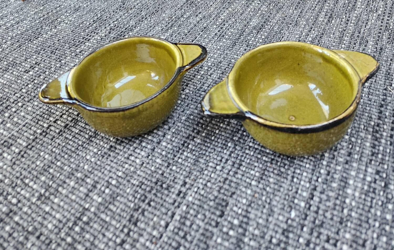 Set of 2 glazed khaki clay bowls.
