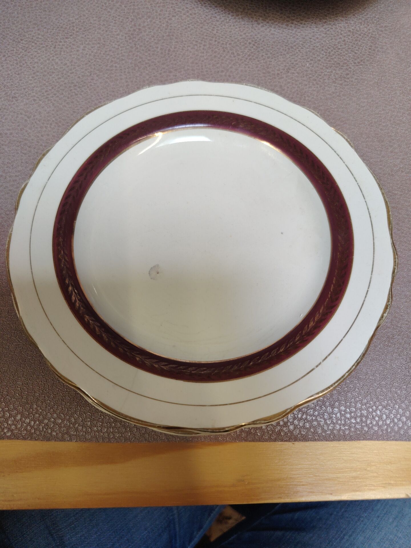 Salins white ceramic dessert plates with red trim and gold rim.