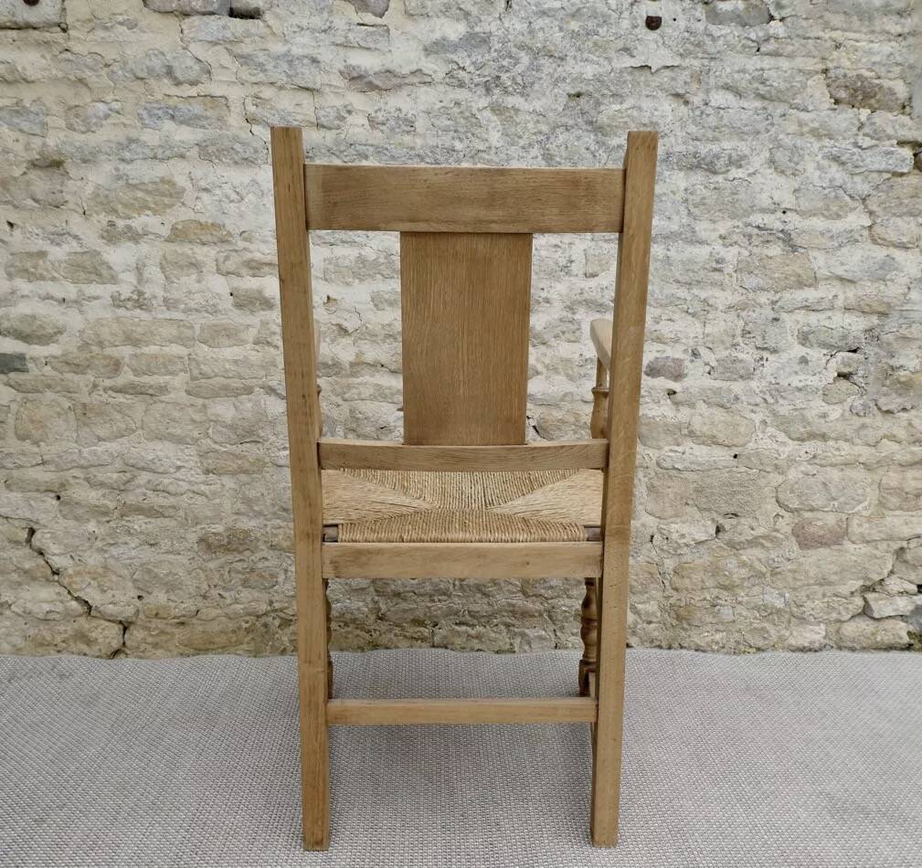 Light wood neo-Basque armchair with caned seat.