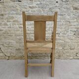 Light wood neo-Basque armchair with caned seat.