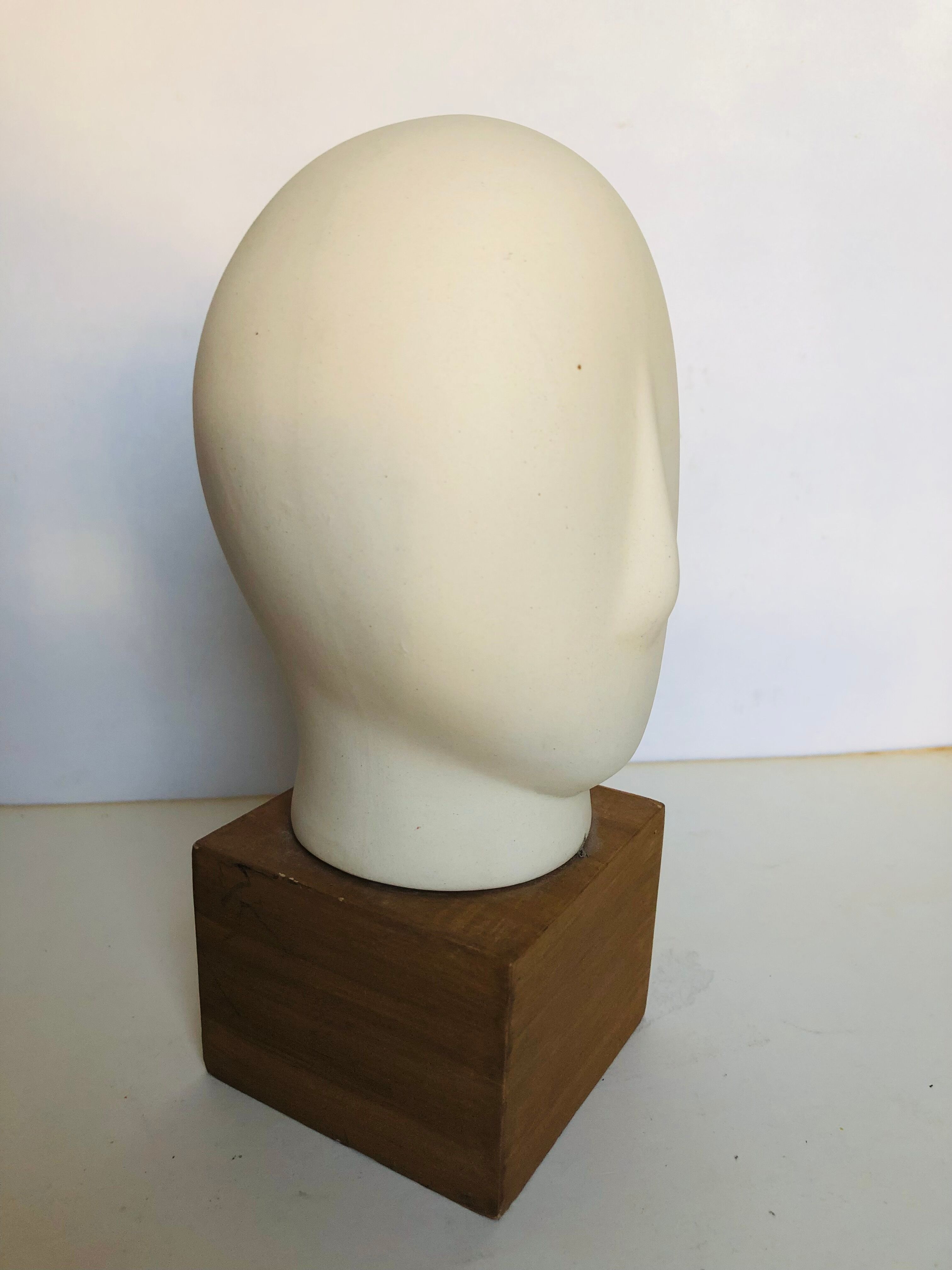 Ceramic head on wooden base