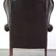 Chesterfield wing chair in dark brown leather with a luxurious appearance