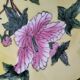 A pair of vintage Chinese decorative plates with floral designs on a yellow background.