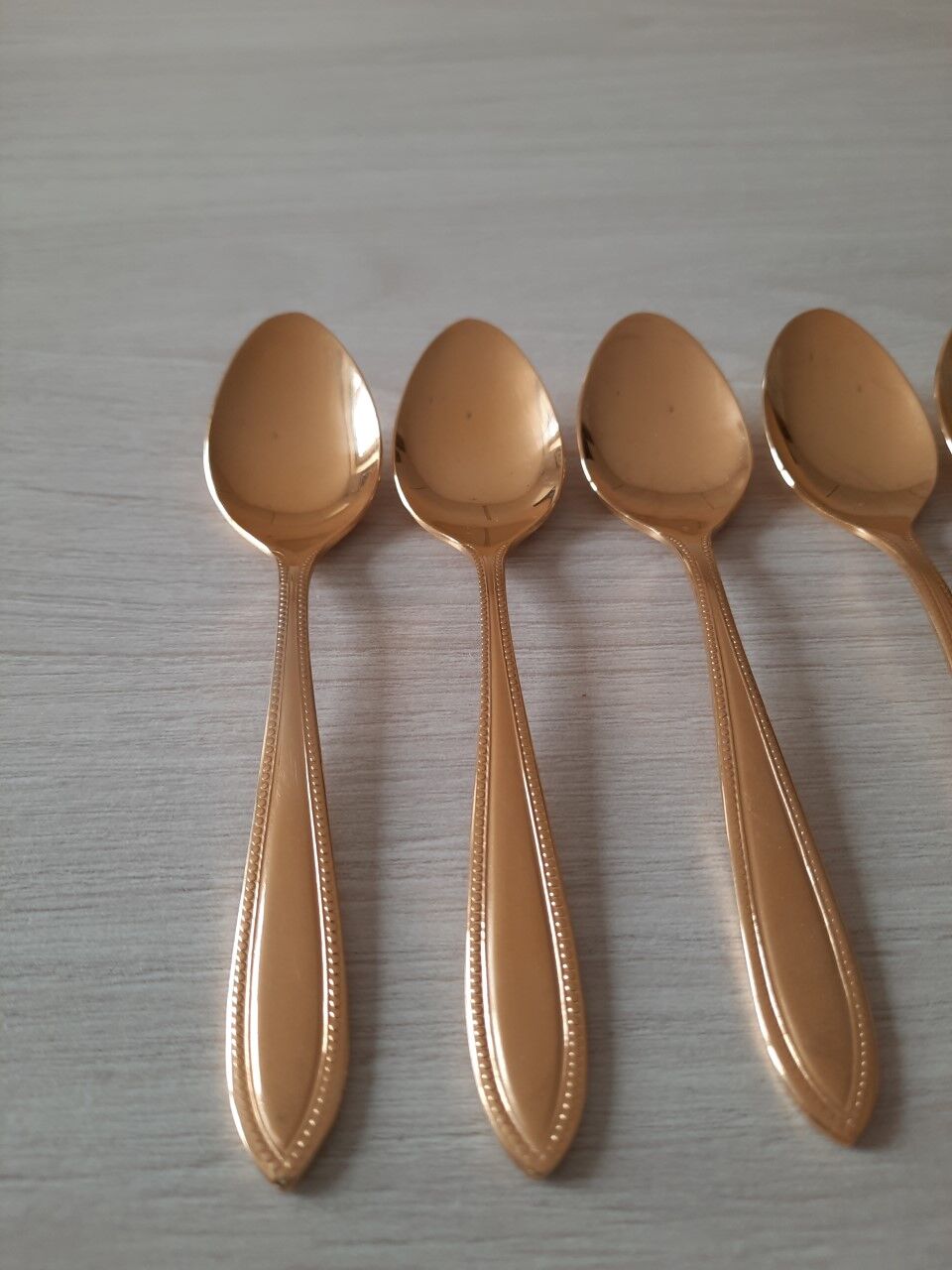 Small golden metal spoons