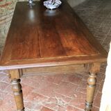 Old French farmhouse table in walnut with turned legs.