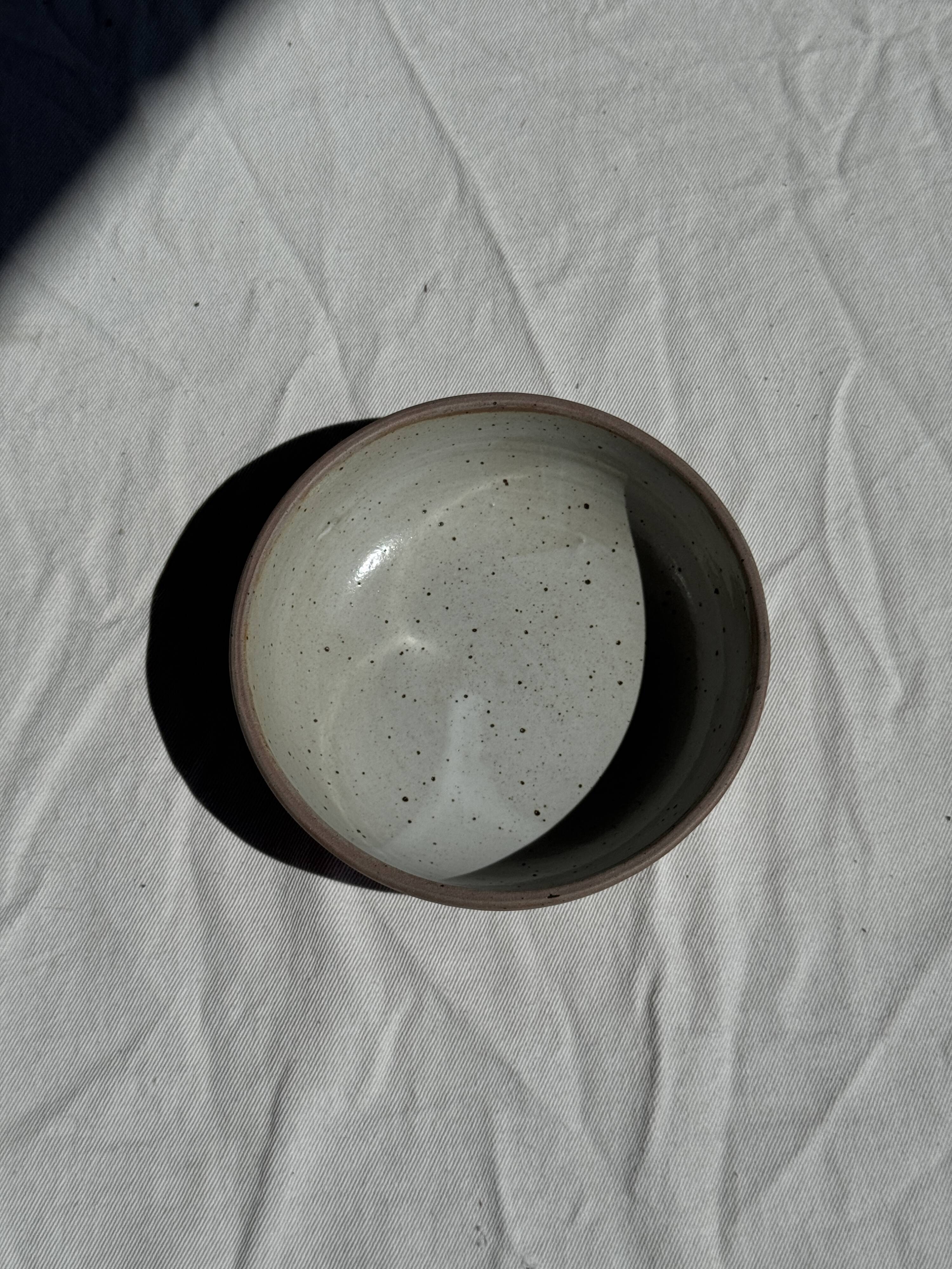 A speckled grey interior bowl with a matte brown exterior H5 D15
