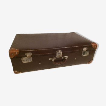 Suitcase vintage leather inside and brown carpeted home
