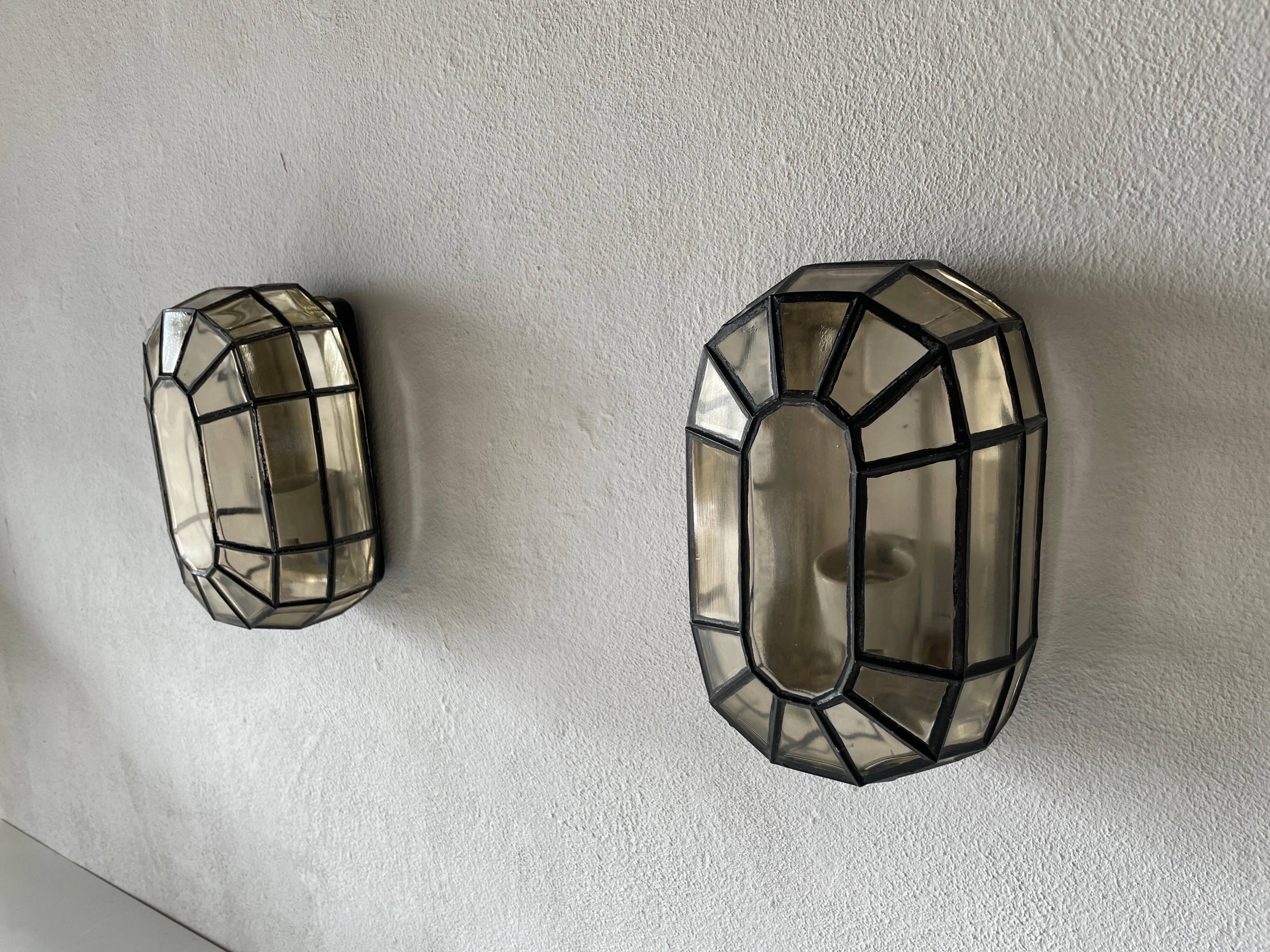 Pair of black iron wall sconces with structured glass by Limburg, 1960s, Germany.