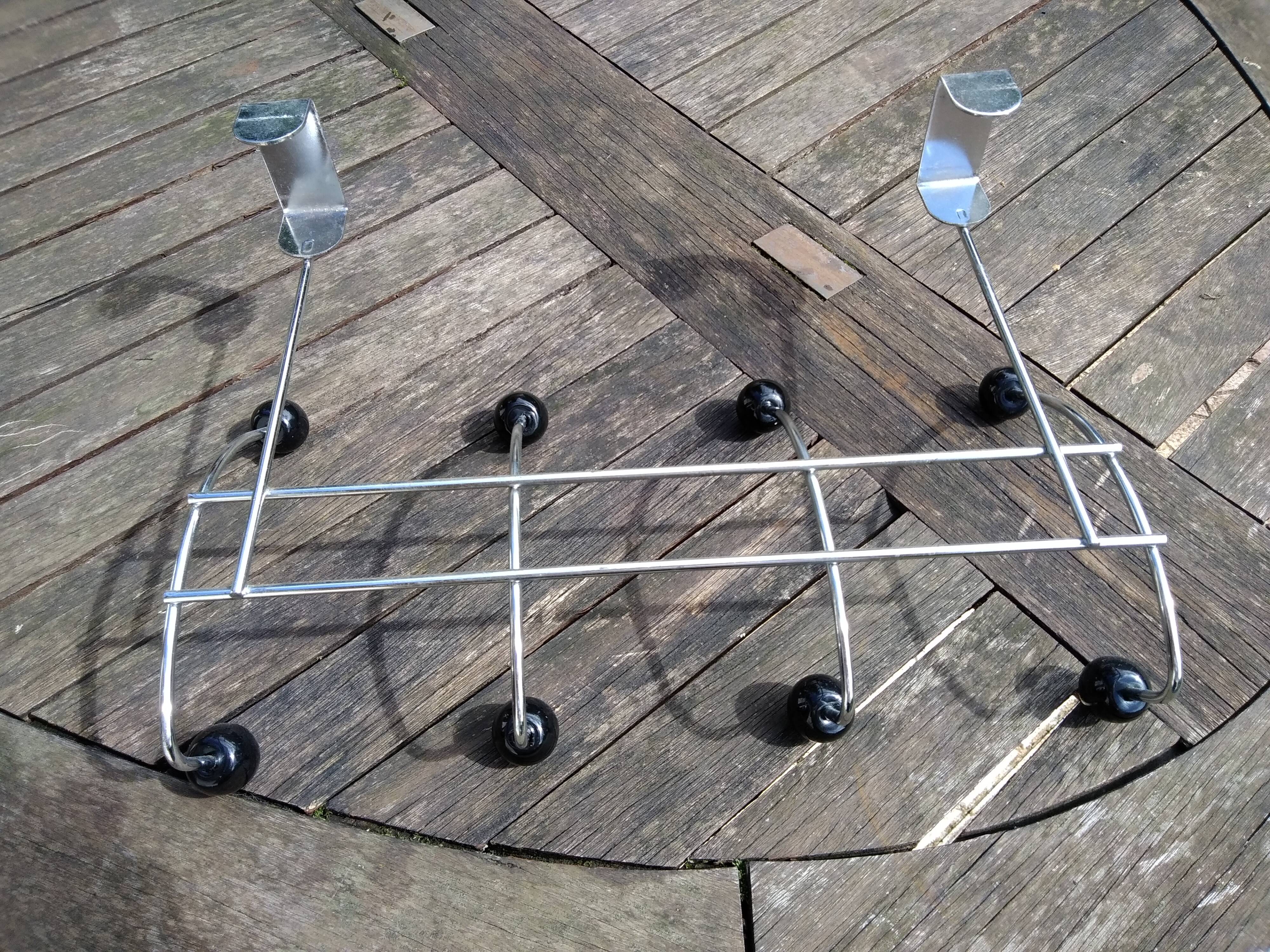 Coat rack that hangs at the top of a door