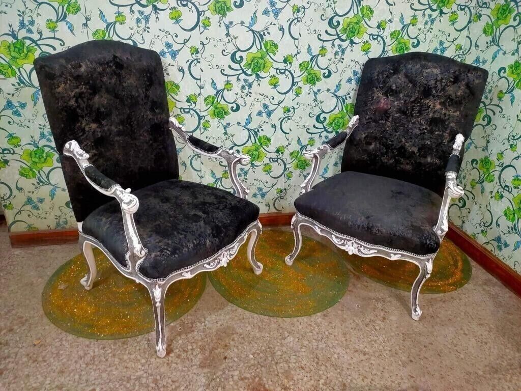 Black Louis XV style armchairs