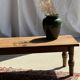 Brown Indonesian teak coffee table, with a border and cylindrical legs H40 L103.