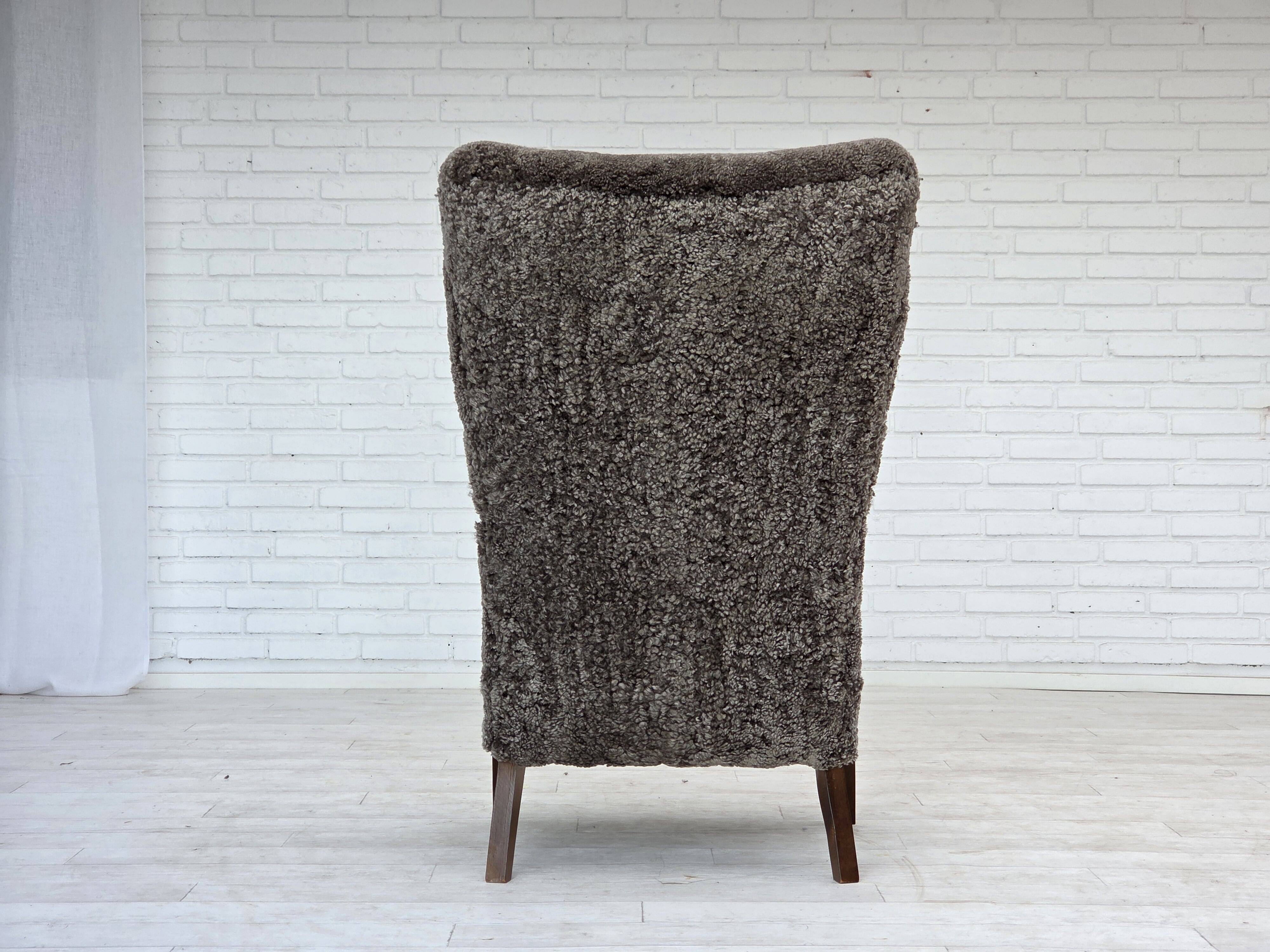 1960s, reupholstered Danish armchair, with stool, genuine sheepskin.