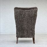 1960s, reupholstered Danish armchair, with stool, genuine sheepskin.