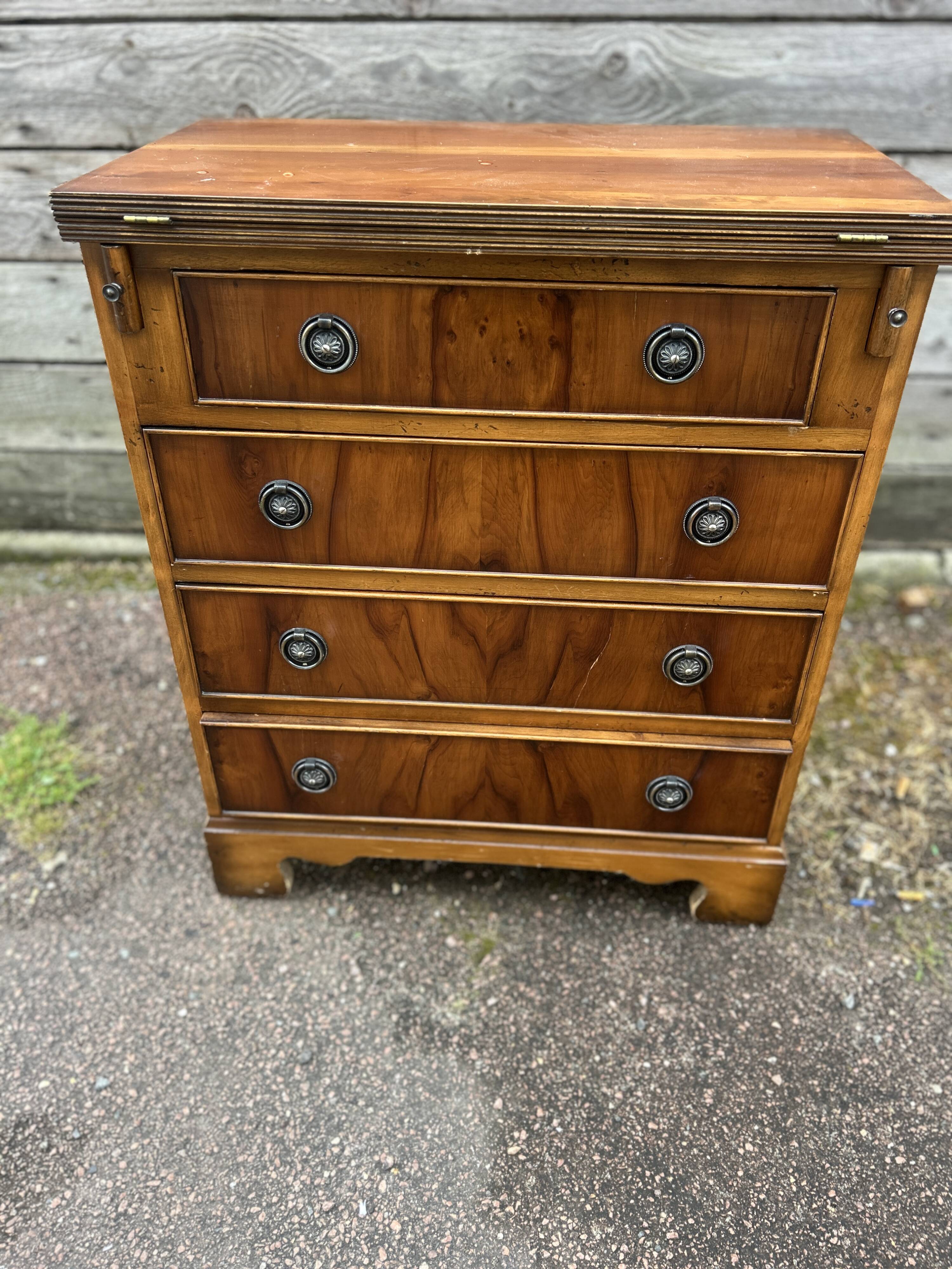 Small English chest of drawers with a folding top.