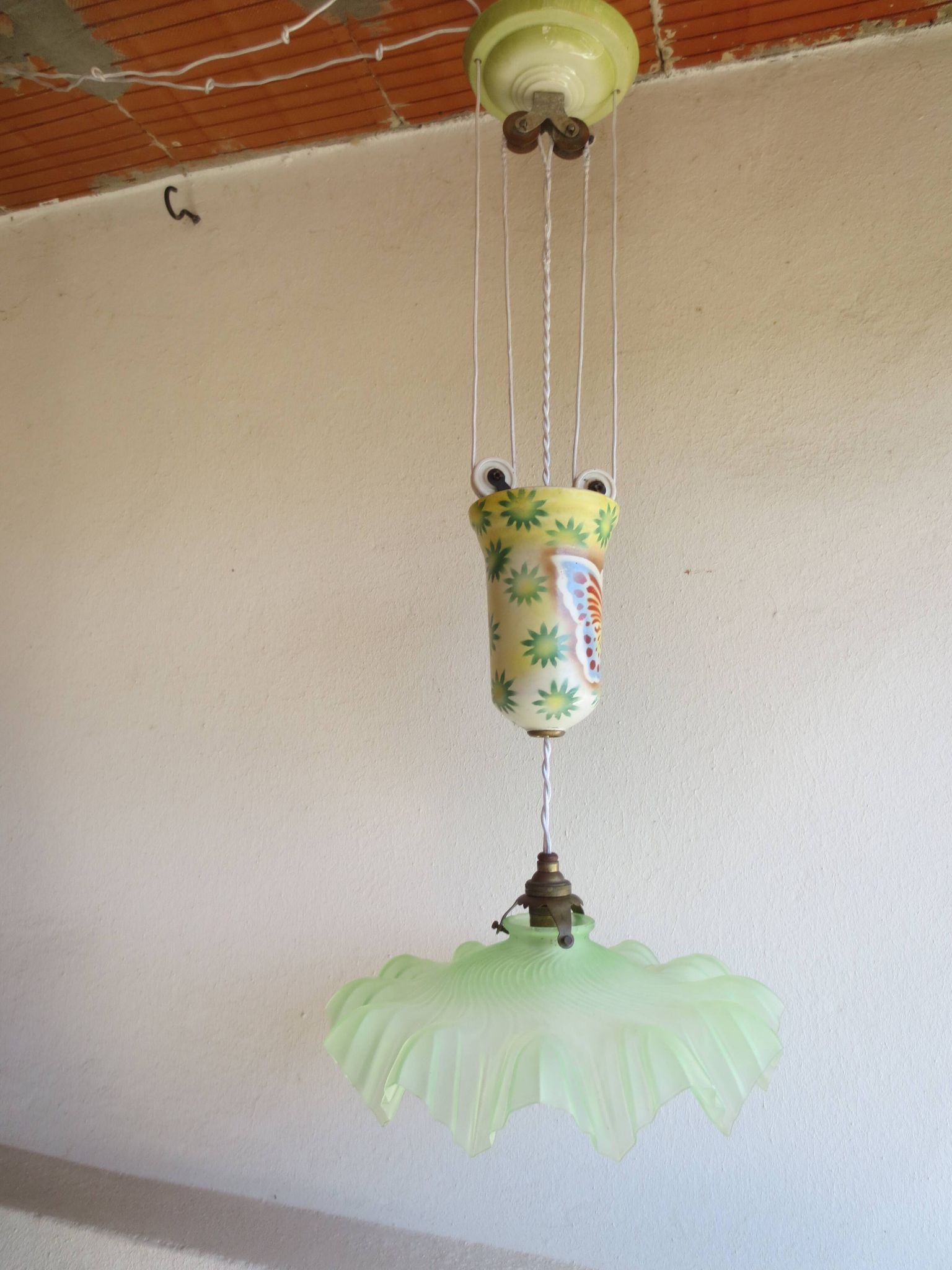 "Very old light fixture" with a "rise and fall" counterweight adorned with butterflies.