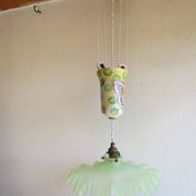 "Very old light fixture" with a "rise and fall" counterweight adorned with butterflies.