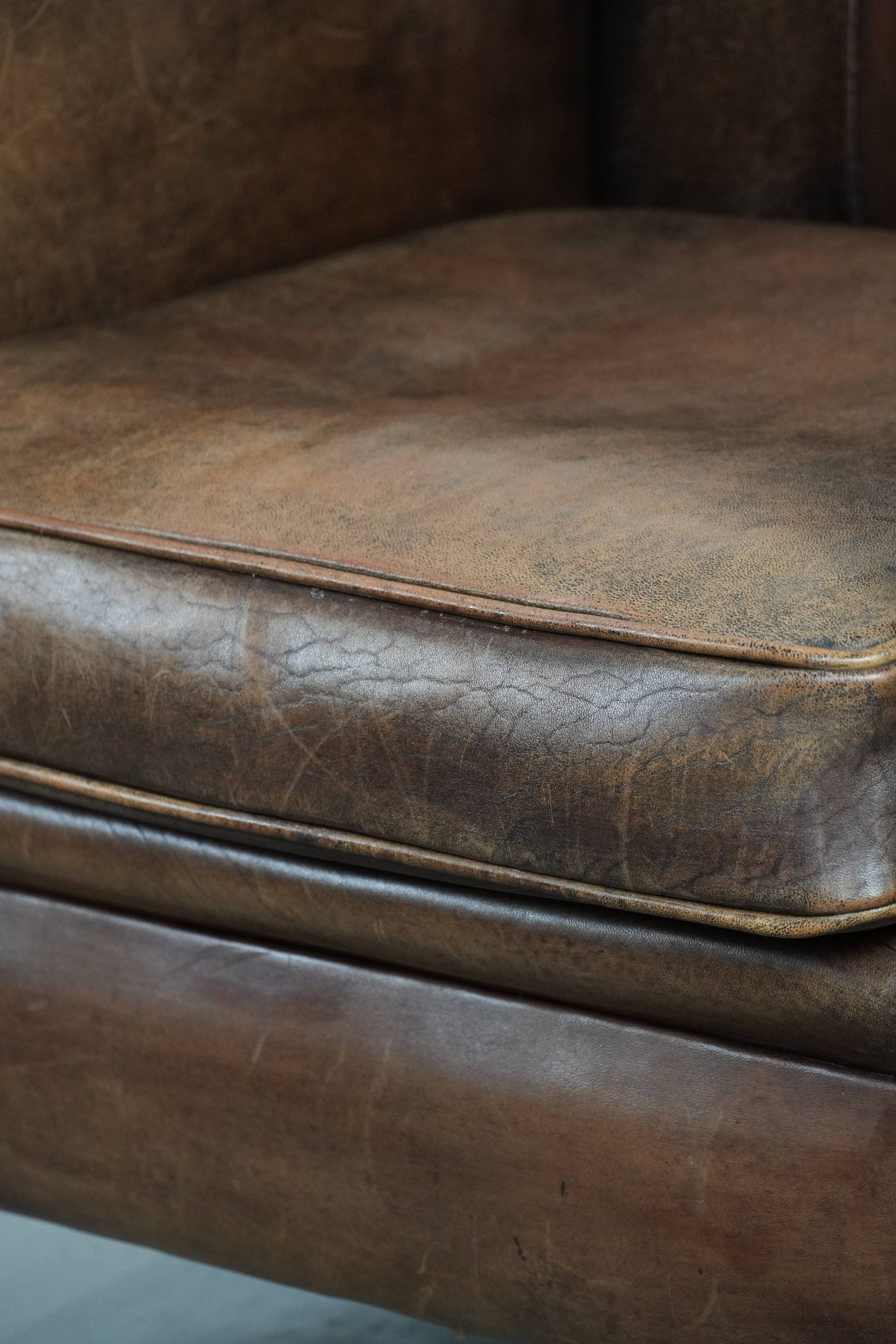 Vintage sheepskin armchair with warm colours and a characterful appearance