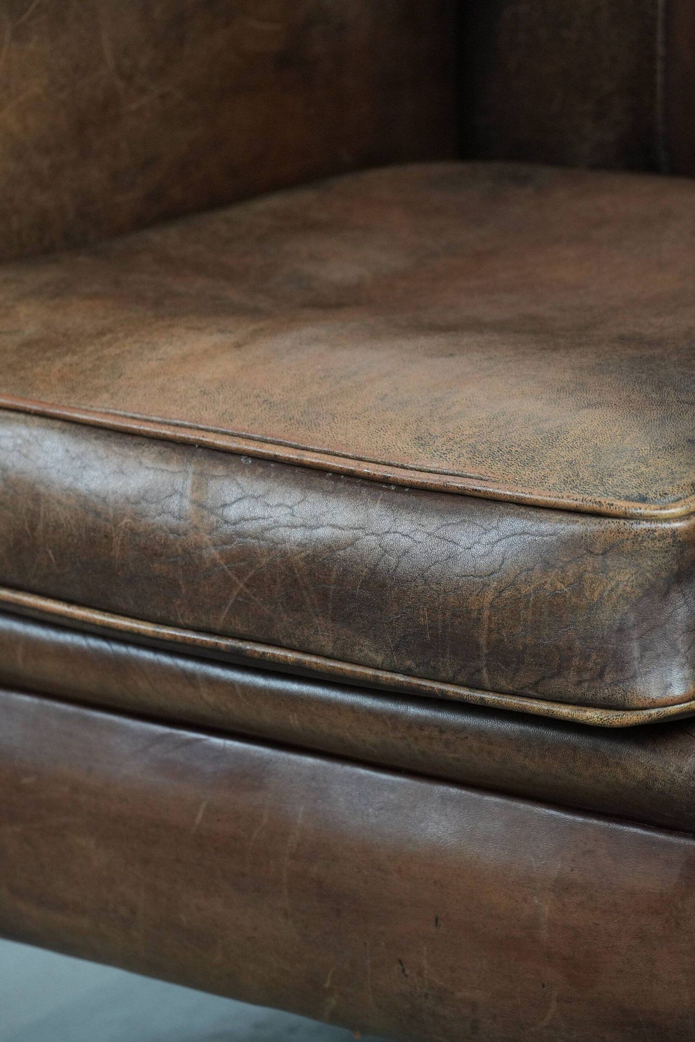 Vintage sheepskin armchair with warm colours and a characterful appearance