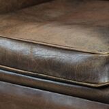 Vintage sheepskin armchair with warm colours and a characterful appearance