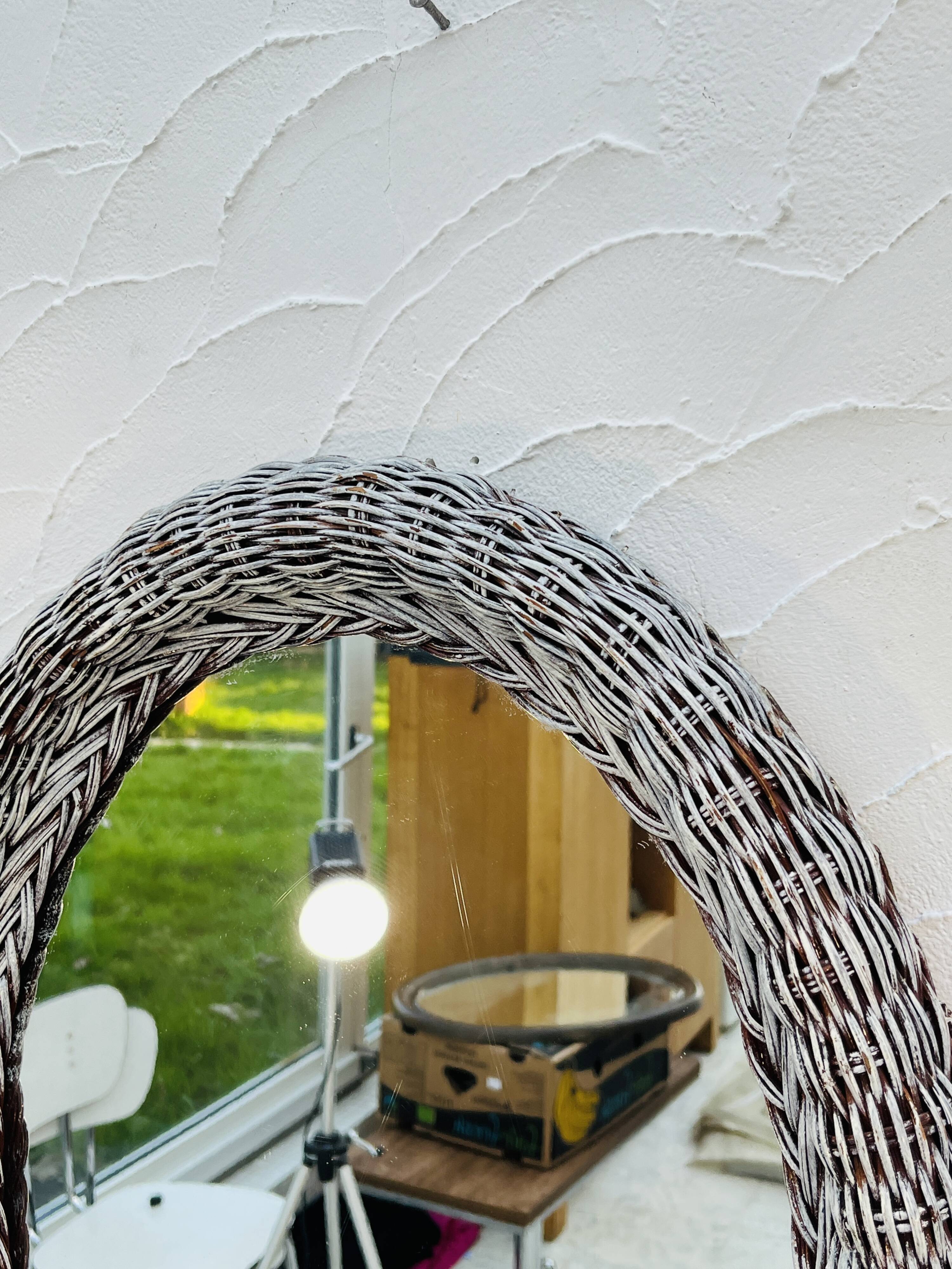 Vintage oval wicker mirror from the 1960s.