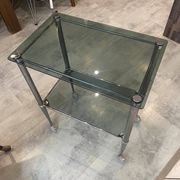 Serving dessert trolley with 2 smoked glass shelves and metal structure.