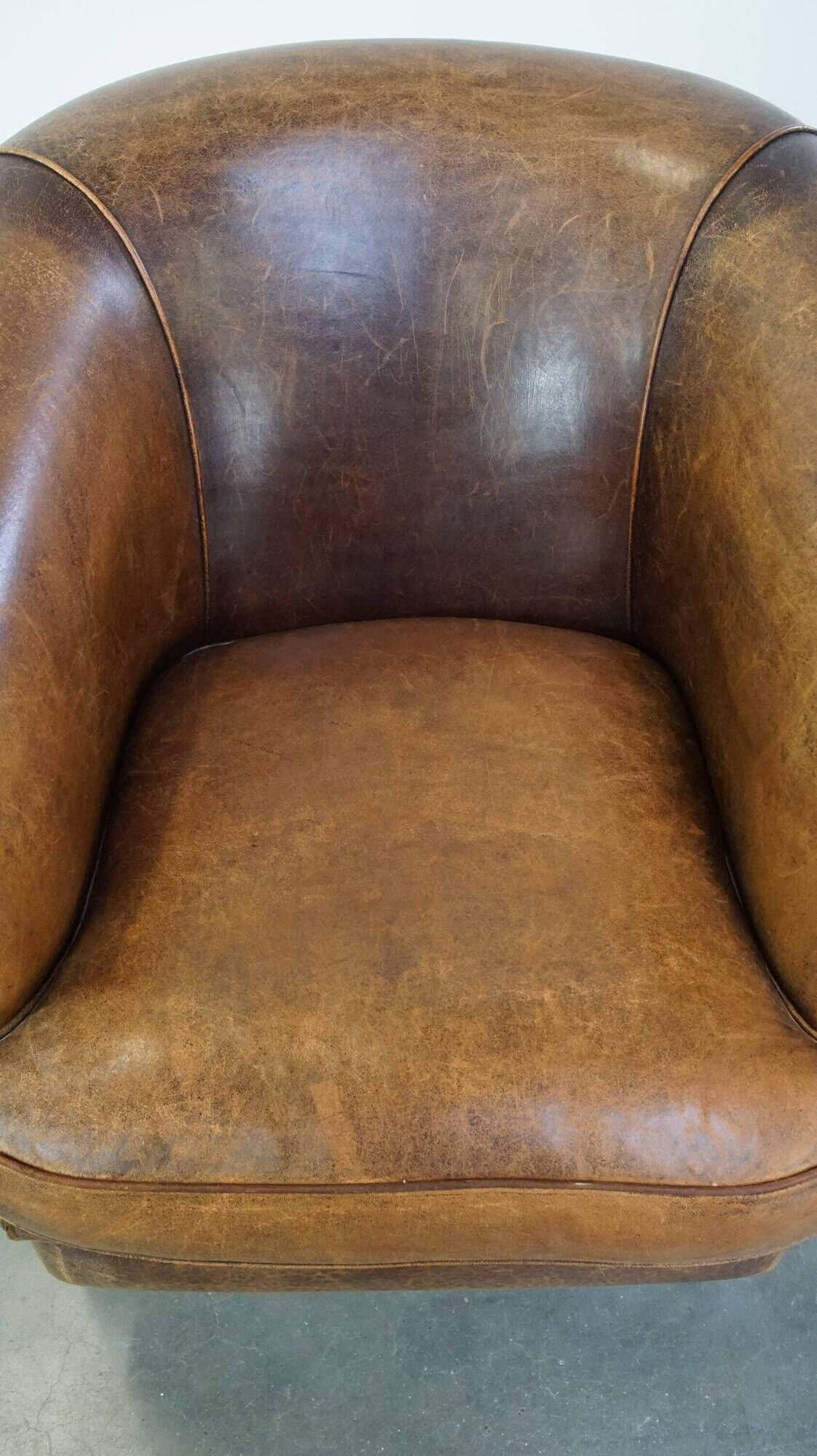 Characterful sheepskin leather club armchair with a luxurious, rustic appearance