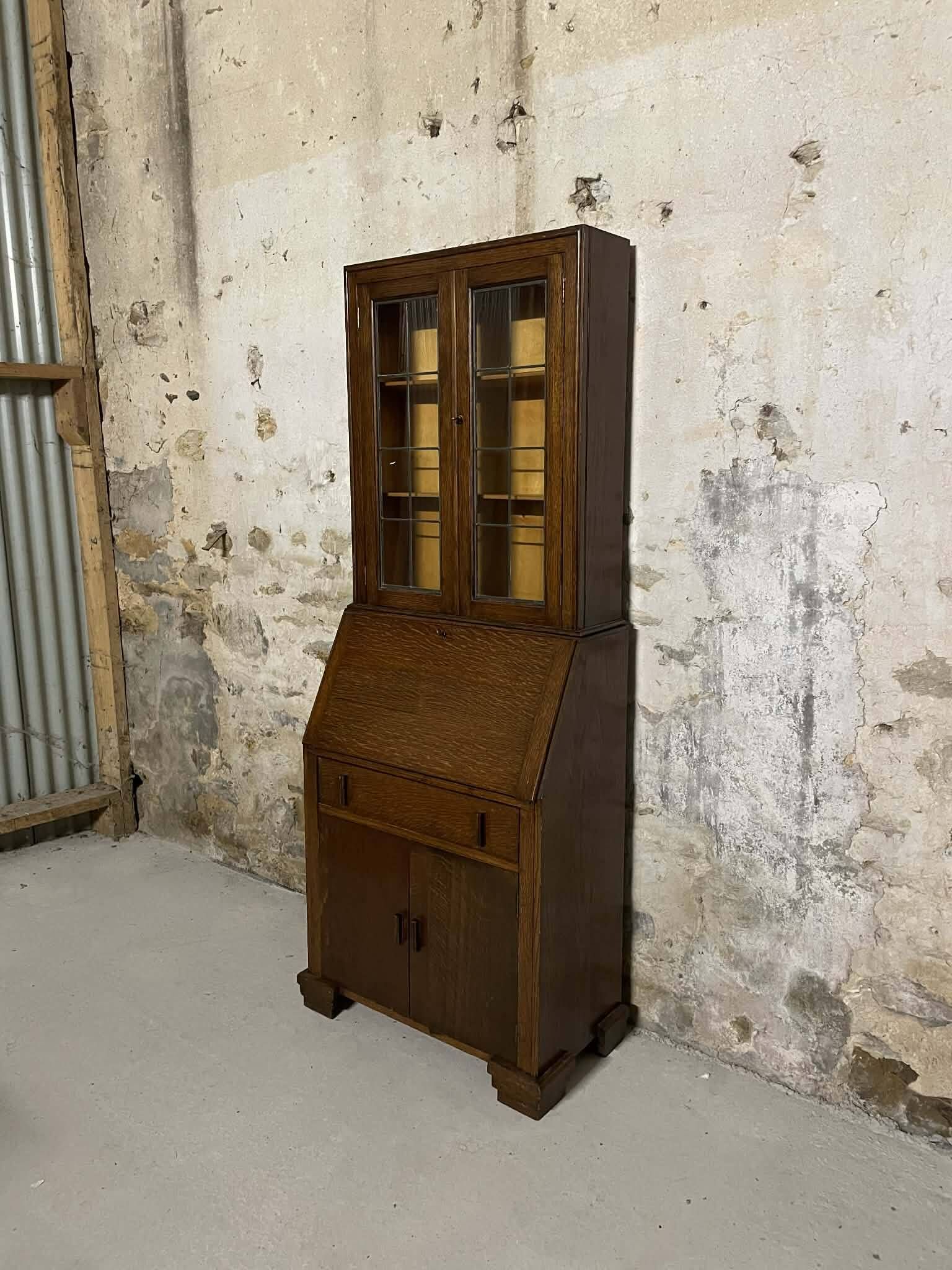 Oak display secretary cabinet with drop-down front, two sections.