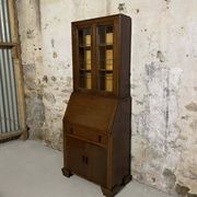 Oak display secretary cabinet with drop-down front, two sections.